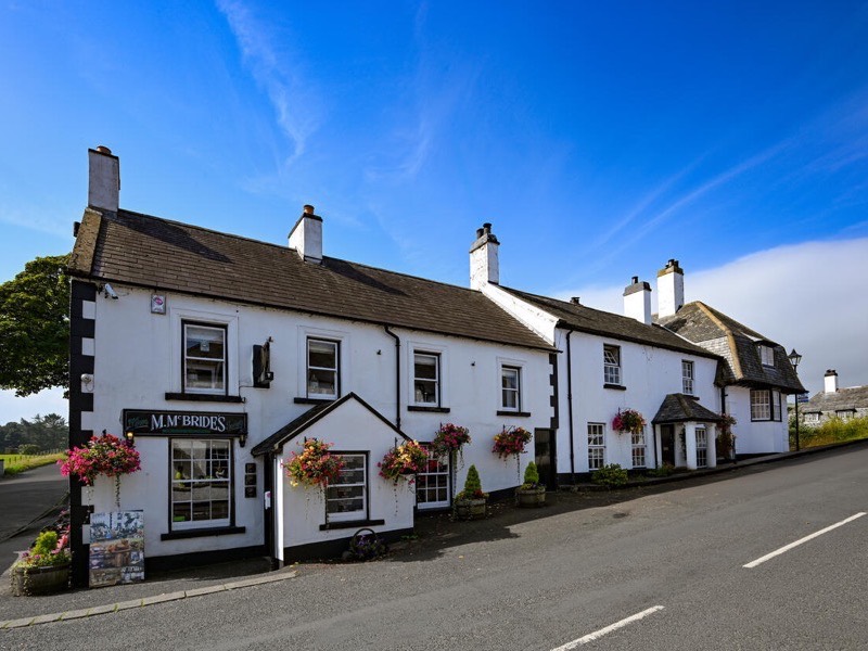 White-washed houses and McBride's pub on the main street in Cushendun, County Antrim